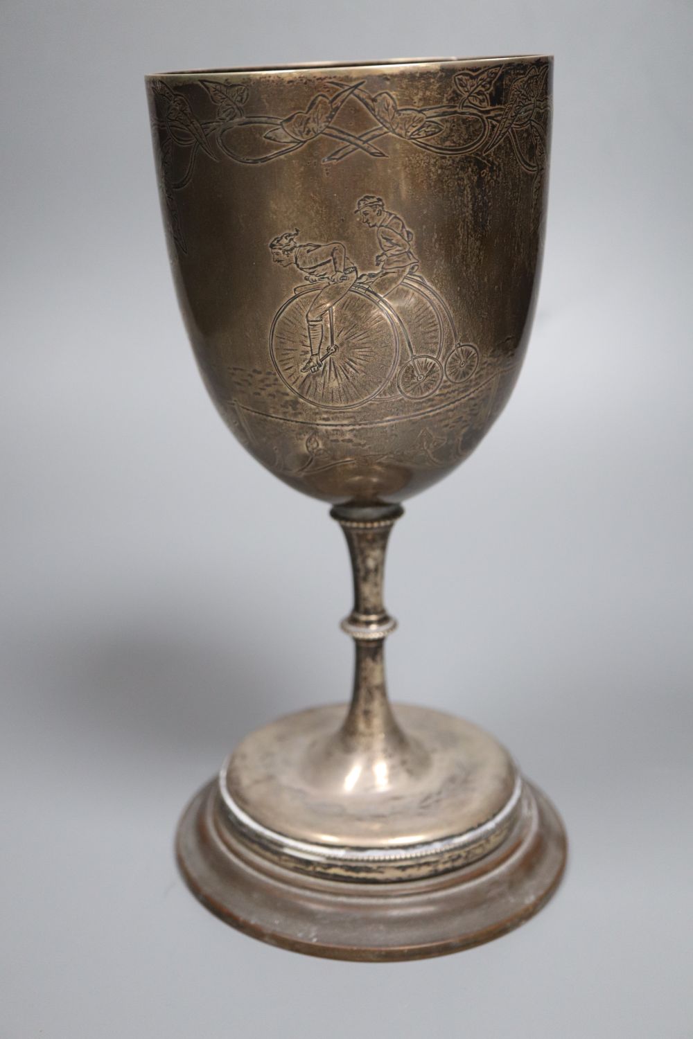 A Victorian silver presentation trophy goblet, engraved with a Penny Farthing, Birmingham, 1879, 22.6cm, weighted,